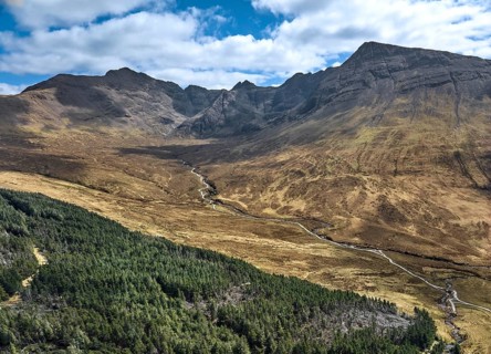 Aerial panoramic drone photo landscape of the Black Cuillins mountain chain with the tourist