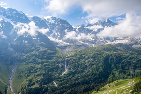 Schmadribachfall waterfall and picturesque mountain landscape with Breithorn mountain peak, Bernese