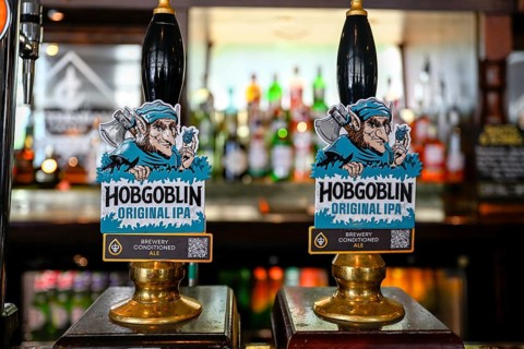 Hobgoblin Original IPA Ale taps at the bar counter, London, England, Great Britain