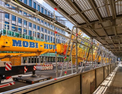 Mobi Hub, heavy construction machine with special technology setting up a crane in the narrow