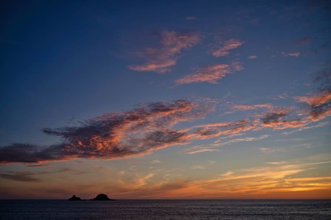 Sunset, sunset at sea, dramatic clouds, in the background rock formation The Brisons, Cot Valley