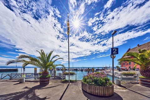 Lake Lake Constance, road, flagpole, lantern, planter with palm tree, flower pot, metal railing,