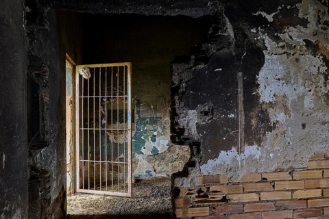 Gloomy scene in an old building with destroyed walls and a partially opened door, Lost Place,