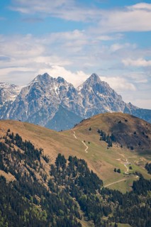 Two high mountain hills with a visible hiking trail through the green countryside, Hahnenkamm,