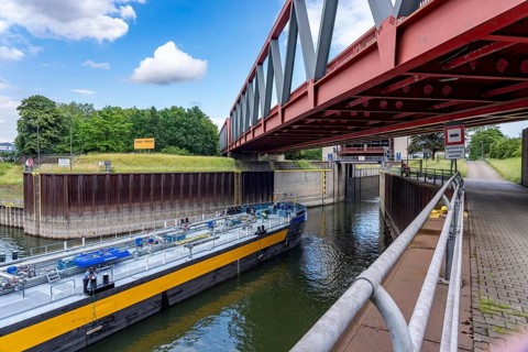 Cargo ship, tanker, leaves the port canal in the port of Duisburg-Ruhrort, enters the