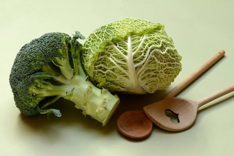 Savoy cabbage and broccoli with cooking spoon