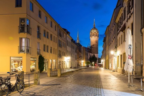 Coswiger Straße in the evening with castle church tower, Luther city Wittenberg, Saxony-Anhalt,