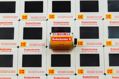 Old roll of 1970s 35mm Kodachrome II color reversal slide film for daylight shooting on top of