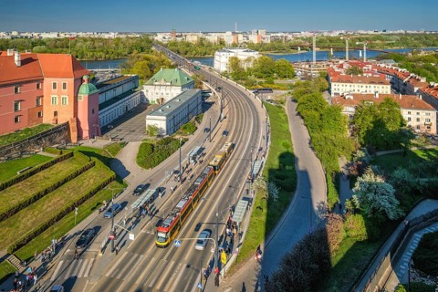 Elevated view over Warsaw W-Z Route with tram lane, road traffic, Royal Castle gardens, red