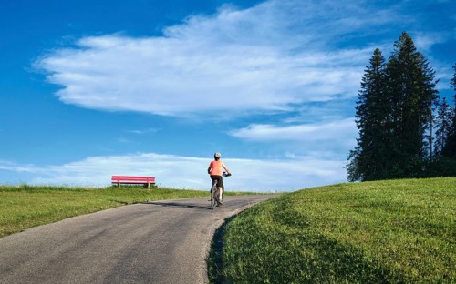 Active senior woman rides her electric mountain bike in Westallgäu near Lindenberg, Bavaria,