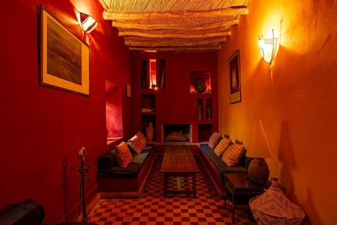 Orientally furnished interior with traditional wooden ceiling, with seating in a riad, the walls