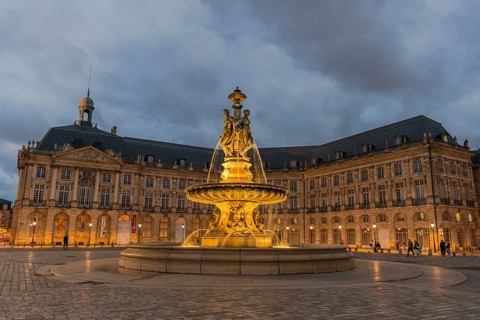Illuminated fountain of the Three Graces on Place de la Bourse, Bordeaux, Gironde, France