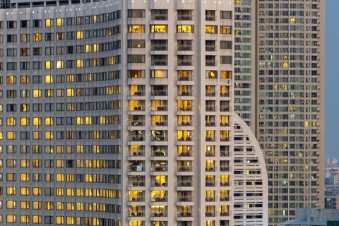 Nocturnal view of the Shangri-La Hotel on the east bank of Chao Phraya, the warmly lit rooms stand
