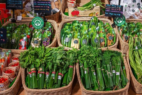 Vegetable and herb sales rack wrapped in banana leaves, Bangkok, Thailand