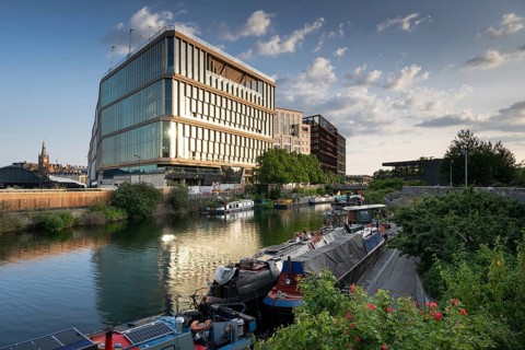 Houseboats moored, office and commercial buildings, Regent's Canal Towpath, Camden Town, London,