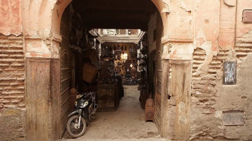 An arch in the old town leads to a Moroccan courtyard in the medina full of antique furniture, with