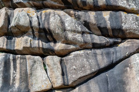 Distinctive, monumental granite rocks cut and weathered by sea and wind, filling formats, on the