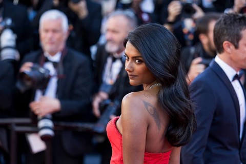 Simone Ashley with Karma on the Red Carpet at the Palais des Festivals et des Congrès during the