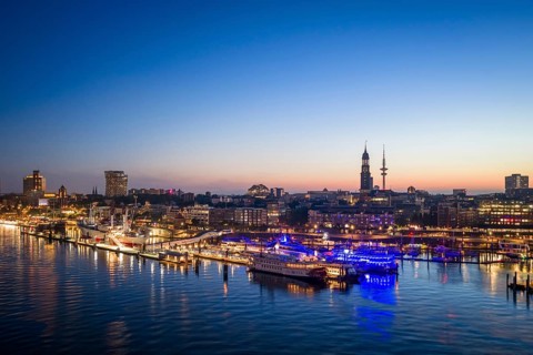 Aerial view of Landungsbrücken at sunrise on the Elbe with St Michael's Church (Michel) and