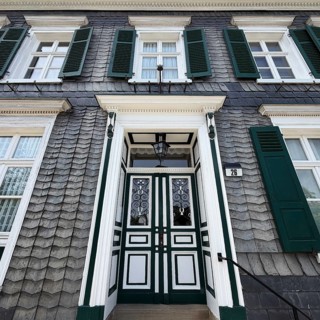 Beautiful front door with slate façade and green shutters, Bergischer Dreiklang, Hückeswagen,