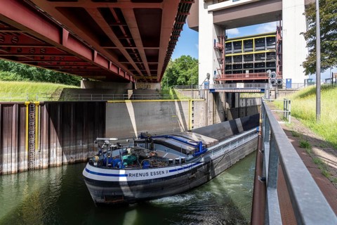 Cargo ship leaving the Duisburg-Meidrich canal lock leaving the Rhine-Herne Canal heading west,