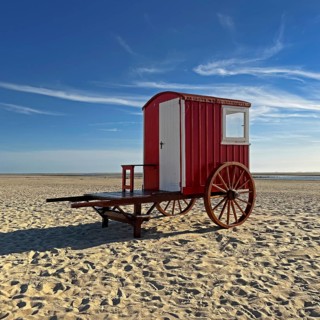 A red bathing cart on the west beach with the sea, North Sea island of Borzburg, East Frisia, Lower