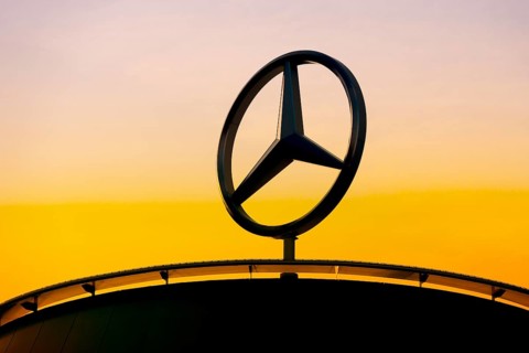 Mercedes-Benz logo in front of a sunset sky, silhouette in the foreground, Stuttgart-Untertürkheim,