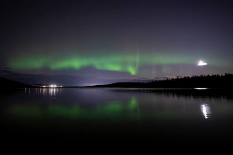 The Northern Lights (Aurora borealis) reflected in a forest lake, Gällivare, Norrbotten, Lapland,