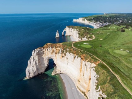 Aerial view of the La Manneporte rock gate in the evening sun, behind it the Porte d'Aval rock
