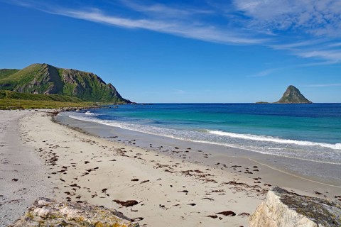 White sandy beach with views of mountains and a distant island under clear skies, Bleik, Bleiksoya,