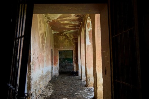 An old abandoned corridor with peeling paint and arches in a historic building, Lost Place,