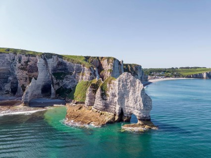 Aerial view of the Falaise d'Amont rock formation with the Porte d'Amont rock gate at low tide,