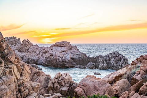Landscape of the coastline with blue water at Costa Paradiso on a sunny day at sunset, Sardinia,