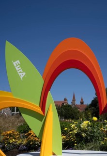 EurA AG logo on a symbol, a sculpture of a flower, with the Protestant Town Church and the