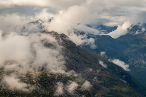 View of mountains lying partly in clouds from the 1476 meter high mountain peak and viewpoint