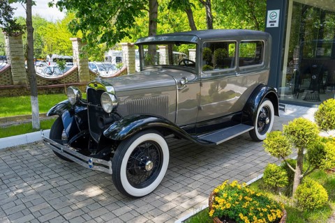 Elegant gray classic car on paving stones in a green park, vintage car, Ford Model A, Milestii Mici