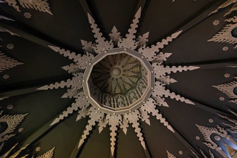 Decorated vaulted ceiling of the public prayer hall in the Buddhist temple complex Wat Phra That