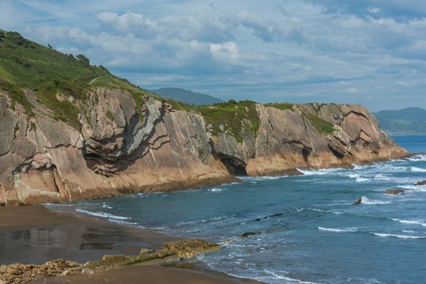 Distinctive rock cliffs as a geological formation of rock layers, Flysch on Itzurun Beach in