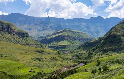 Mountainous landscape of the Cathedral Range mountains and green mountain valley, Drakensberg