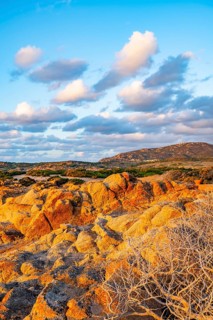 Evening atmosphere with clouds over the landscape at Marinedda Coast on a sunny day, Sardinia,