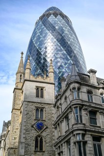 Medieval church of St Andrew Undershaft in front of The Gherkin, nicknamed one of London's most