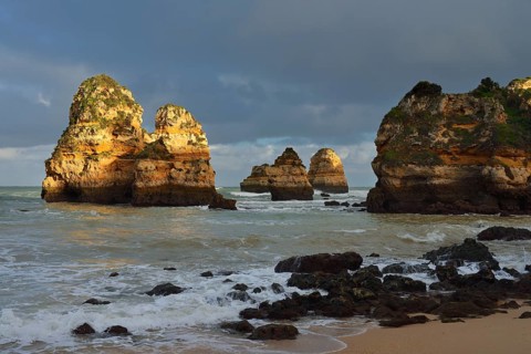Rock formations on the coast in the evening light, Praia do Camilo, Lagos, Algarve, Portugal