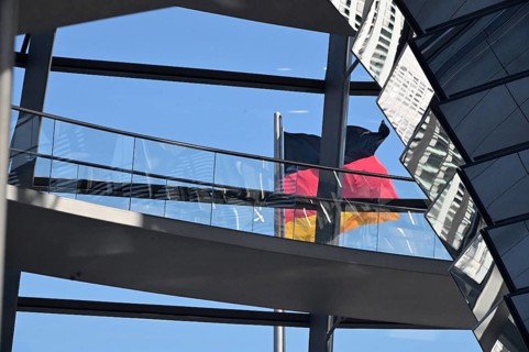 German flag behind glass Reichstag dome
