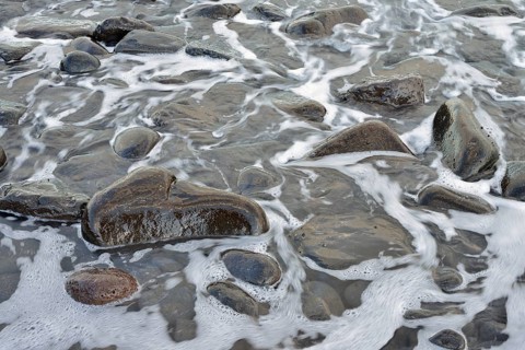 Waves wash stones on the beach, Fuerteventura, Canary Islands, Spain
