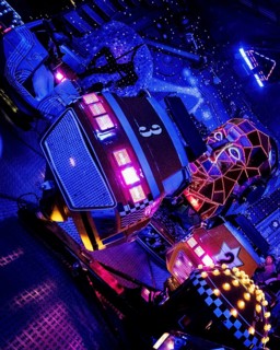 Carousel in neon light, evening at a funfair, Lübeck, Germany