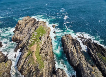 Aerial drone photo of rocky cliffs and heavy atlantic ocean surf, Strathy point, northern Scotland,
