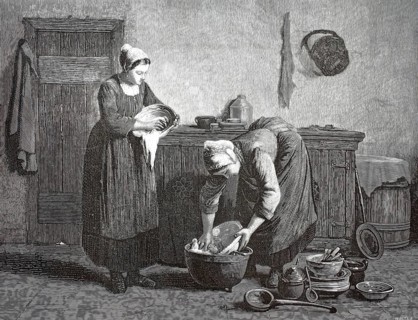 After dinner. Kitchen or service maids washing and scrubbing dishes in a historic kitchen. A woman