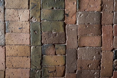 Detailed view, floor with old earth-colored bricks crisscrossed by cracks, church, Husby Church,