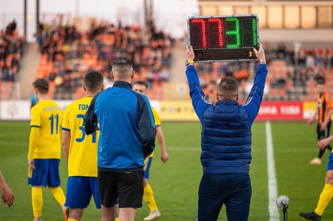 Man shows players substitution during football match in Lubin, Poland