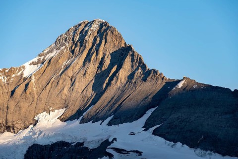 Impressive high-alpine landscape, Eiger mountain peak with alpine glow at sunrise, Bernese Alps,